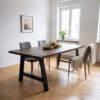 Dining table with dark wooden top and black A-shaped table legs, 55/82 × 72 cm